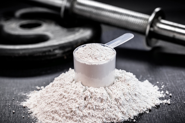Creatine powder with scoop